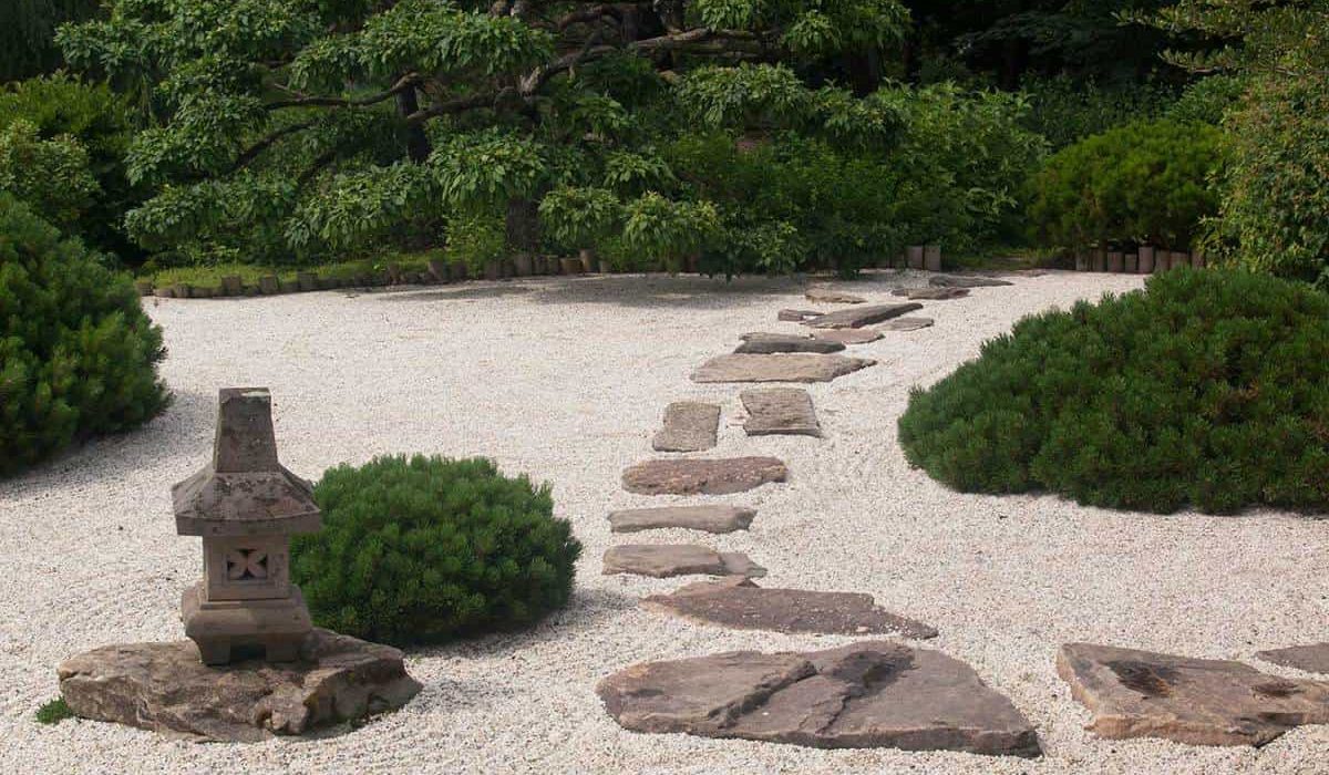 Green-shrubbery-and-a-stone-pathway-in-a-japanese-zen-garden
